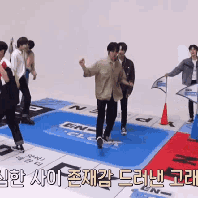 a group of young men are playing a game on a mat that says ' en ' on it