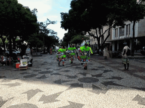 a group of people are walking down a street with a sign that says ' coca cola '