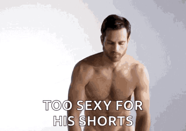a shirtless man is standing in front of a white wall and says too sexy for his shorts .