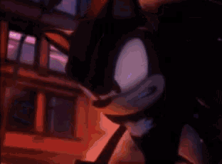 a close up of shadow the hedgehog 's face with a blue background