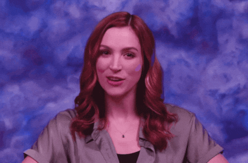 a woman with red hair is smiling with the words of your failure behind her