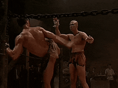 a man is kicking another man in the face