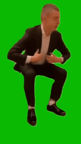 a man in a tuxedo is adjusting his jacket on a green screen .