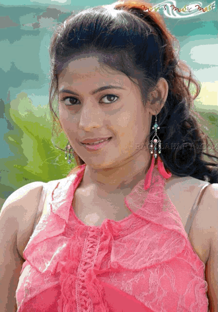 a woman wearing a pink top and earrings is featured on a website called baahubali.com