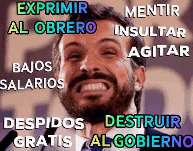 a man with a beard is smiling in front of a microphone surrounded by spanish words