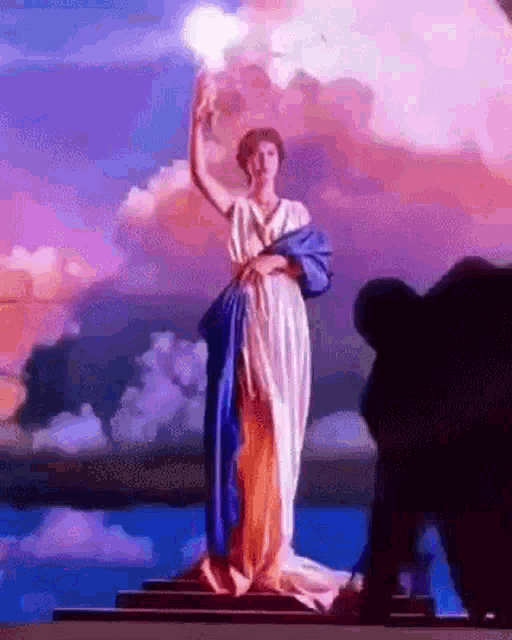 a statue of a woman in a blue and white dress holding a light .