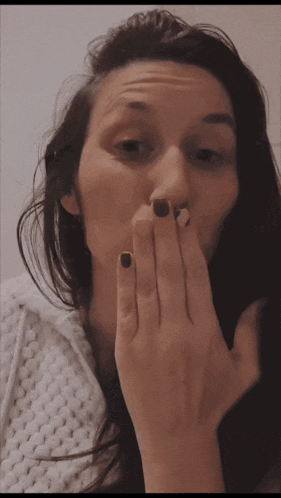 a woman covering her mouth with her hand