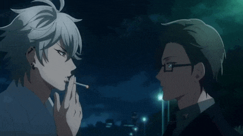 a man is smoking a cigarette while another man looks on .