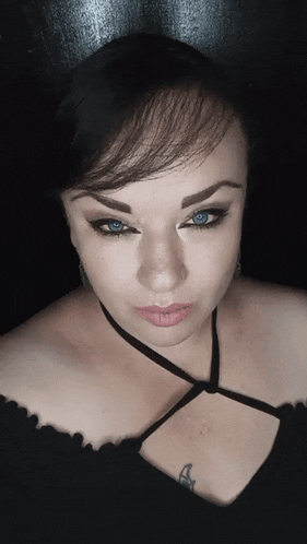 a close up of a woman 's face with blue eyes