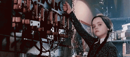 a girl with pigtails is working on a machine