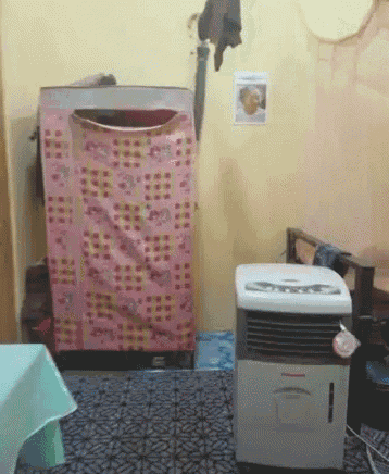 a room with a washer and dryer and a portable air conditioner