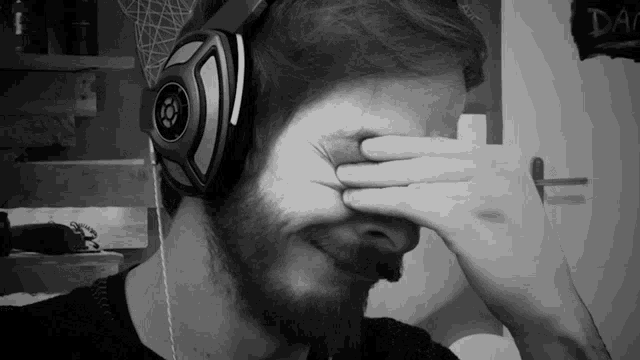 a man wearing a pair of headphones covering his eyes