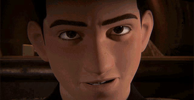 a close up of a young man 's face with a serious look on his face