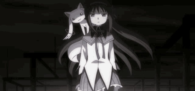a girl with a cat on her shoulder is standing in the dark