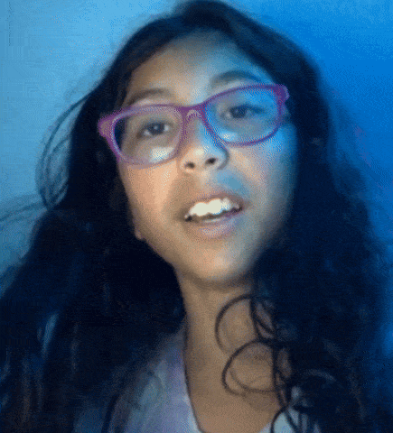a young girl wearing glasses and a purple shirt