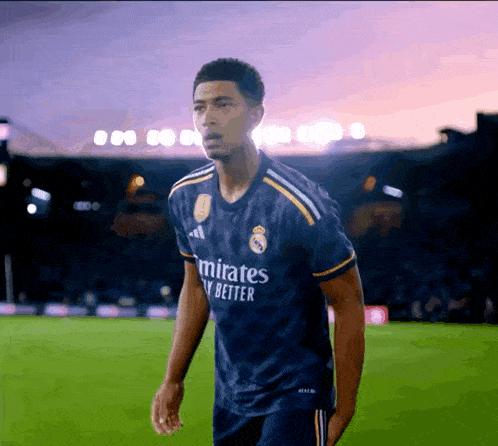 a man wearing a blue emirates fly better jersey