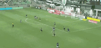 a group of soccer players are playing on a field with subway advertisements on the sidelines