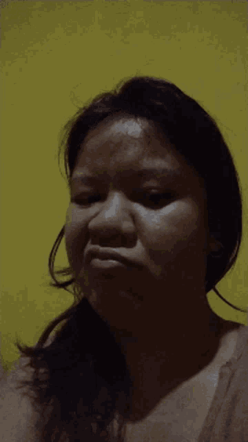 a close up of a woman 's face against a yellow background