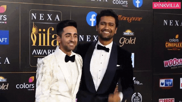 two men are posing for a picture on a red carpet sponsored by nexa and pinkvilla