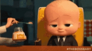 a baby in a suit and tie is sitting in a high chair being fed by a woman with a spoon .