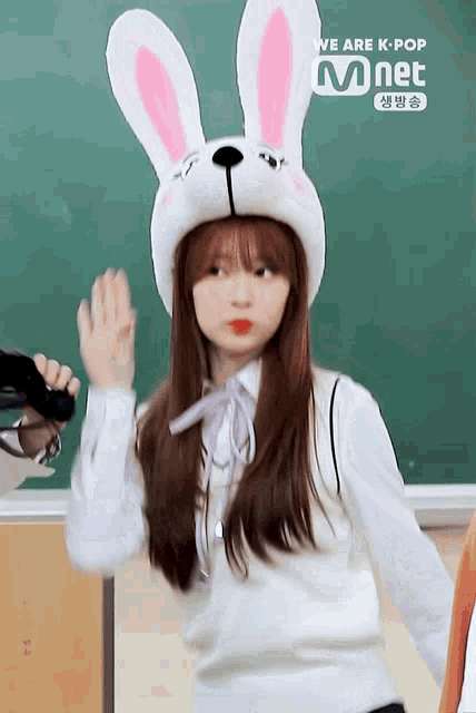 a girl wearing a bunny hat says we are k-pop