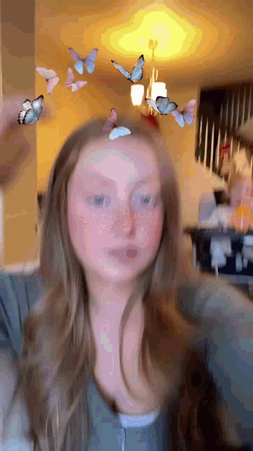 a girl with butterflies flying around her head