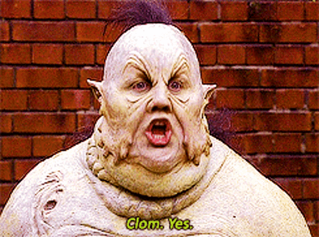 a man in a clown costume says " clom yes "
