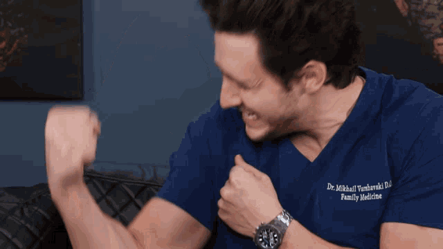 a man wearing a blue shirt that says dr. mikhail verhnowski