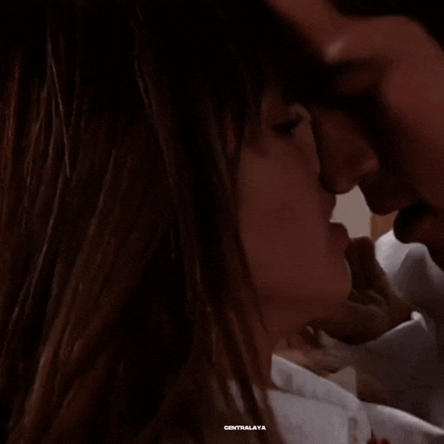 a close up of a man and woman kissing with centralaya written on the bottom right