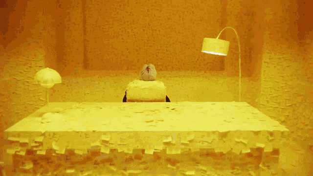 a person is sitting at a desk that is covered in sticky notes