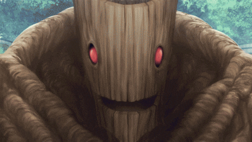 a wooden monster with red eyes and a smile on his face