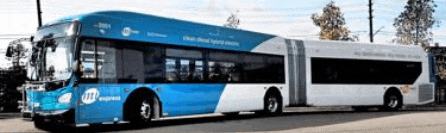 a blue and white bus is driving down a street .