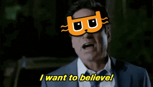 a man in a suit and tie wearing a mask that says i want to believe