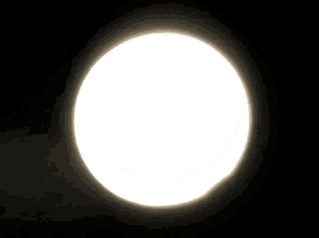 a crescent moon is visible in the dark sky