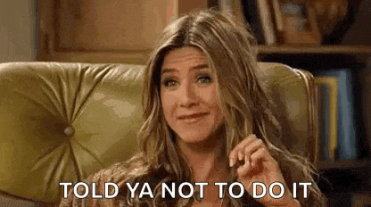 a woman is sitting in a chair and making a funny face .