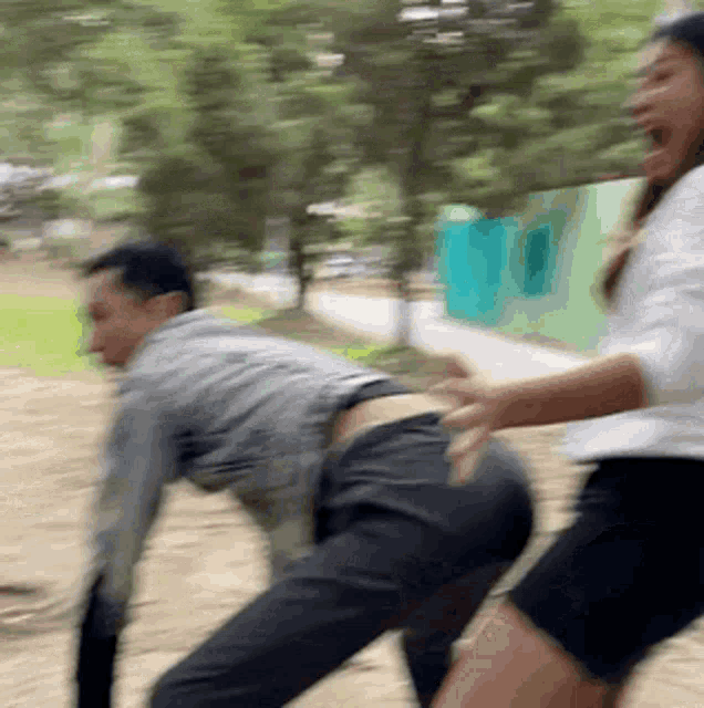 a blurry picture of a man and a woman playing a game
