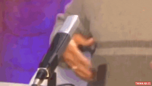 a close up of a person holding a microphone with the words think jules below
