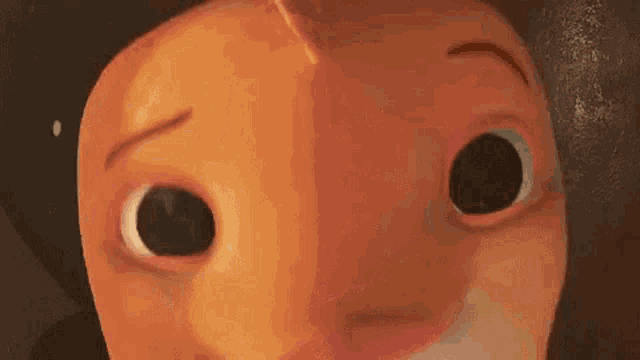 a close up of a fish 's face with a drop of water coming out of its mouth .