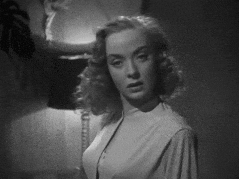 a black and white photo of a woman in a white dress