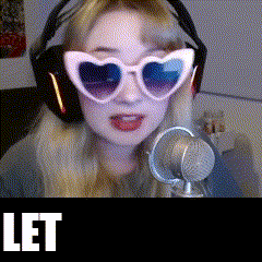 a woman wearing heart shaped sunglasses and headphones stands in front of a microphone with the word let in the corner