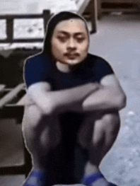 a person squatting down with their arms crossed