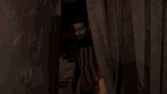 a man with a beard is wearing a red striped shirt