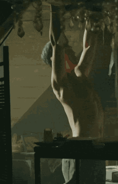 a man without a shirt is hanging upside down