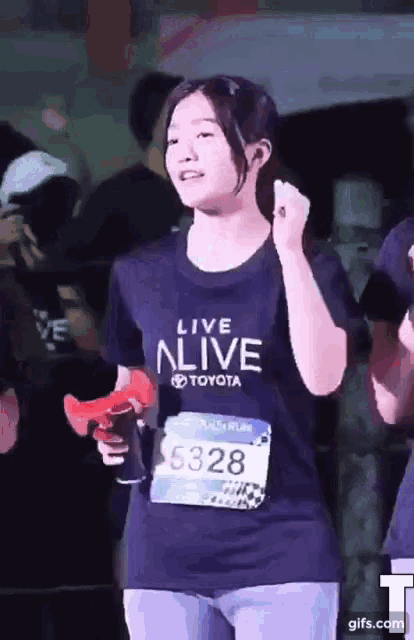 a girl wearing a shirt that says live alive toyota