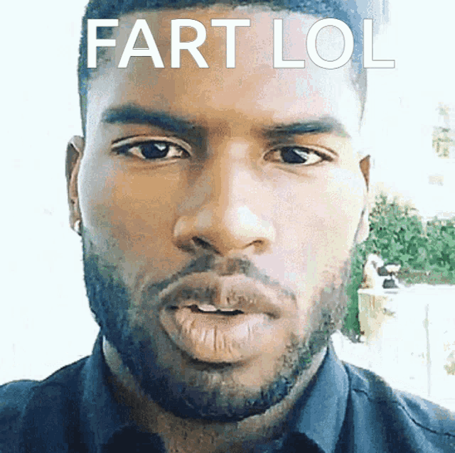 a close up of a man 's face with the words fart lol on the bottom