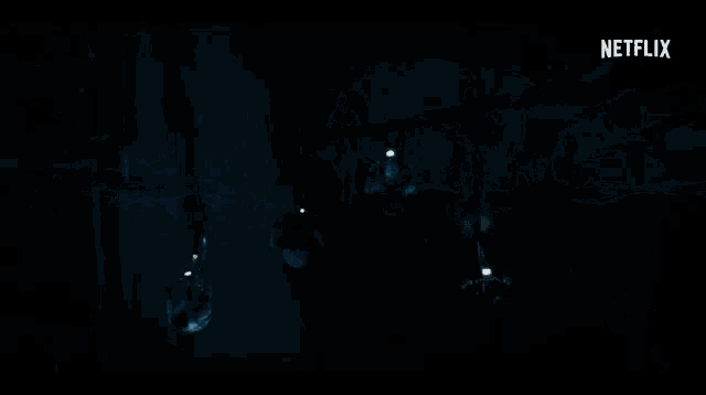 a netflix logo can be seen in the corner of a dark room