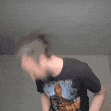 a man wearing an iron maiden t-shirt is dancing
