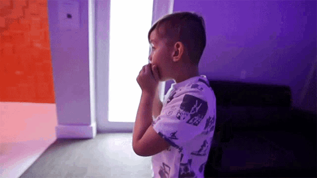 a young boy wearing a shirt with a skull and crossbones pattern