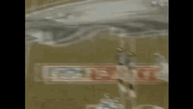 a football game is being played on a field with a sign that says playoffs on it .