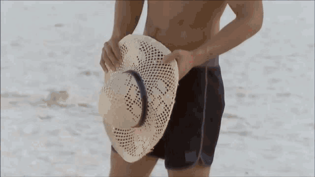 a woman in a bikini stands in front of the ocean and the word golosa is on the bottom right